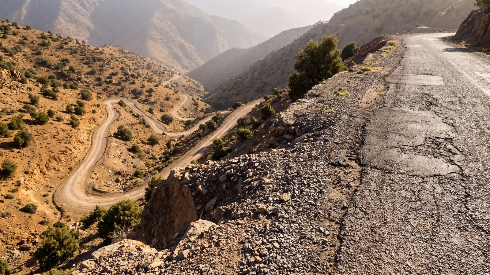 Edge of a mountain road without a guardrail in the High Atlas, with hairpin bends below